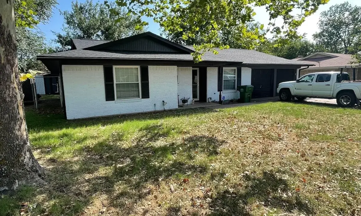 Professional roofing crew working on a residential roof in Benton